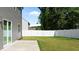 A well-maintained backyard with a concrete patio and white privacy fence at 1028 Gallivant Way, Wake Forest, NC 27587
