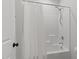 Bathroom with tile shower, tub, brushed nickel hardware and white shower curtain at 1028 Gallivant Way, Wake Forest, NC 27587