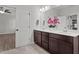 Modern bathroom featuring double sinks and quartz countertops, adjacent to bedroom at 1028 Gallivant Way, Wake Forest, NC 27587