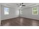 Large bedroom features wood floors, three windows and a ceiling fan at 1028 Gallivant Way, Wake Forest, NC 27587