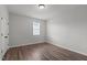 A well-lit bedroom with neutral walls and hardwood flooring at 1028 Gallivant Way, Wake Forest, NC 27587