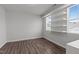 A minimalist bedroom with floating shelves and neutral walls and hardwood flooring at 1028 Gallivant Way, Wake Forest, NC 27587