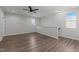 Bonus room has a ceiling fan, light walls, wood flooring and natural light from two windows at 1028 Gallivant Way, Wake Forest, NC 27587