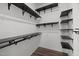 Walk-in closet with black metal shelving, ample storage and hardwood flooring at 1028 Gallivant Way, Wake Forest, NC 27587