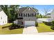 Charming two-story home features a well-manicured lawn, neutral siding and a two-car garage at 1028 Gallivant Way, Wake Forest, NC 27587