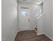 Bright foyer with wood-look floors and white door with windows at 1028 Gallivant Way, Wake Forest, NC 27587