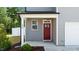 Charming front door is a bright red, and complements the gray siding on this craftsman-style home at 1028 Gallivant Way, Wake Forest, NC 27587
