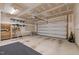 Spacious garage with automatic door, shelving and ample room for vehicle parking and storage at 1028 Gallivant Way, Wake Forest, NC 27587