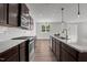 Well-equipped kitchen featuring stainless steel appliances, granite countertops, and modern backsplash at 1028 Gallivant Way, Wake Forest, NC 27587