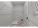 A well-lit laundry room with wire shelving and patterned linoleum flooring at 1028 Gallivant Way, Wake Forest, NC 27587