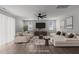 Spacious, virtually staged living room with contemporary furniture, ceiling fan, and hardwood floors at 1028 Gallivant Way, Wake Forest, NC 27587