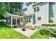 A gorgeous backyard features a fire pit, beautiful plantings and a screened-in porch at 103 Chapelwood Way, Cary, NC 27518
