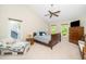 A serene bedroom features vaulted ceilings, a ceiling fan, and natural light from multiple windows at 103 Chapelwood Way, Cary, NC 27518