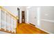 Welcoming foyer with hardwood floors, staircase, and decorative cabinet under natural light at 103 Chapelwood Way, Cary, NC 27518
