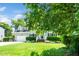 Two-story home featuring a manicured lawn, attached garage, and mature trees under blue skies at 103 Chapelwood Way, Cary, NC 27518