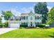 Charming two-story home featuring a manicured lawn, attached garage, and beautiful landscaping at 103 Chapelwood Way, Cary, NC 27518