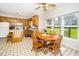 Bright kitchen with a view to the yard, featuring a wooden table with chairs and modern appliances at 103 Chapelwood Way, Cary, NC 27518