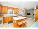 Bright kitchen with wooden cabinets, a central island with seating, and open layout at 103 Chapelwood Way, Cary, NC 27518