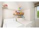 Functional laundry room with washer, dryer, and shelving for efficient organization at 103 Chapelwood Way, Cary, NC 27518