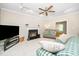 Inviting living room featuring fireplace, ceiling fan and comfortable seating arrangement at 103 Chapelwood Way, Cary, NC 27518
