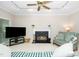 Comfortable living room with fireplace, ceiling fan and plush seating at 103 Chapelwood Way, Cary, NC 27518