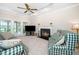 Cozy living room with fireplace, plush seating, and glass doors leading to the patio at 103 Chapelwood Way, Cary, NC 27518