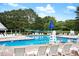 Well-maintained community pool with multiple lounge chairs and tables perfect for summer relaxation at 103 Chapelwood Way, Cary, NC 27518