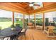 Cozy sunroom with wood ceiling, plenty of windows, and outdoor views to enjoy the backyard at 103 Chapelwood Way, Cary, NC 27518