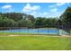 Community tennis courts behind a black chain link fence and large beautiful grassy area at 103 Chapelwood Way, Cary, NC 27518