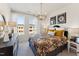 Bright bedroom with a floral accent bed, and a dresser next to a window with lots of natural light at 10518 Pleasant Branch Dr # 33, Raleigh, NC 27614