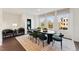 Bright dining room with large windows, seating for six, and stylish decor accents at 10518 Pleasant Branch Dr # 33, Raleigh, NC 27614
