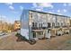 Rear exterior view of a multi-story townhome with private balconies and a spacious yard at 10518 Pleasant Branch Dr # 33, Raleigh, NC 27614