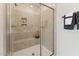 Walk-in shower features updated tile, a built-in seat, and convenient soap and shampoo niche at 10518 Pleasant Branch Dr # 33, Raleigh, NC 27614