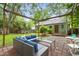 Outdoor patio with gray seating and a pergola, leading to the cozy green house at 109 Davidson Ave, Durham, NC 27704