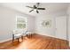 Bright bedroom with hardwood floors, ceiling fan, and two windows with white blinds at 109 Davidson Ave, Durham, NC 27704