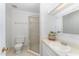 Clean and bright bathroom featuring a shower, vanity, toilet, and ample lighting for a functional space at 113 Spring Cove Dr, Cary, NC 27511
