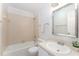 Standard bathroom with a shower and tub combo, neutral tile, and a single sink vanity at 113 Spring Cove Dr, Cary, NC 27511