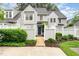 Charming two-story home featuring a well-maintained yard, a welcoming blue front door, and a white picket fence at 113 Spring Cove Dr, Cary, NC 27511