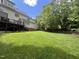 Beautiful backyard featuring a manicured lawn, mature trees and a back deck on the home at 124 Creekvista Dr, Holly Springs, NC 27540