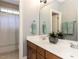 Bright bathroom featuring a double sink vanity with wood cabinets and a shower and tub combo at 124 Creekvista Dr, Holly Springs, NC 27540