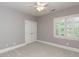 Neutral bedroom featuring a ceiling fan, a window with shutters and a closet with doors at 124 Creekvista Dr, Holly Springs, NC 27540
