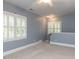 Bonus room illuminated by natural light with windows and plantation shutters and carpeted floor at 124 Creekvista Dr, Holly Springs, NC 27540