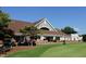 Exterior of the clubhouse with golf carts parked outside and green grass at 124 Creekvista Dr, Holly Springs, NC 27540