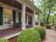 Inviting front porch with comfortable seating and meticulous landscaping enhancing curb appeal at 124 Creekvista Dr, Holly Springs, NC 27540