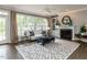 Inviting living room features a fireplace, built-in shelving, and bright windows with elegant furniture at 124 Creekvista Dr, Holly Springs, NC 27540