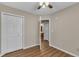 This bedroom features neutral walls, a ceiling fan and a door to the bathroom at 134 Riverwalk Cir, Cary, NC 27511