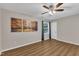 A calming bedroom featuring neutral walls, wood floors, and a ceiling fan with light fixture at 134 Riverwalk Cir, Cary, NC 27511