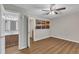 Bright bedroom with wood floors, closet, neutral walls, ceiling fan, and bathroom through doorway at 134 Riverwalk Cir, Cary, NC 27511