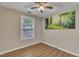 This bedroom boasts wood floors, neutral walls, and a window view, complemented with simple artwork at 134 Riverwalk Cir, Cary, NC 27511