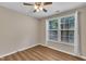 Bright bedroom with two windows, wood floors, and neutral walls creates a simple and clean space at 134 Riverwalk Cir, Cary, NC 27511